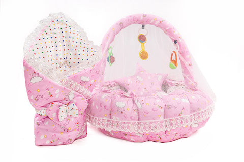 Soft baby snuggle bed with protective net and hanging rattle toys in pink cloud print