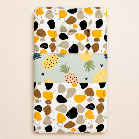 Soft cushioned baby carry nest laid flat unzipped in tropical pineapple pebble print