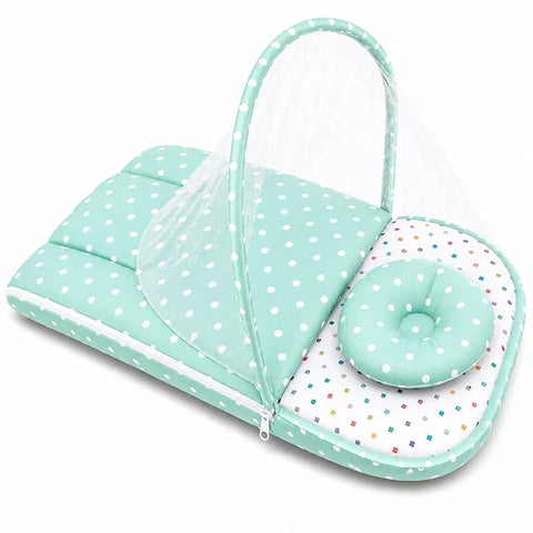 Zip up mosquito mesh net on green polka dot print baby carry nest
