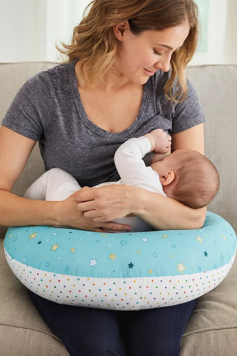 Mother using sky blue star print nursing pillow for comfortable breastfeeding