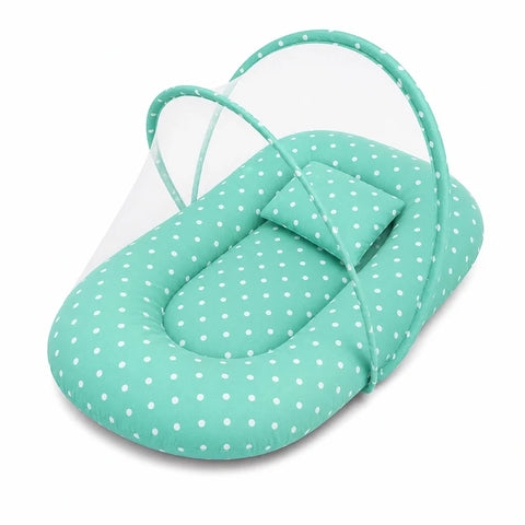 Baby mosquito net bed with matching pillow in green polka dot print