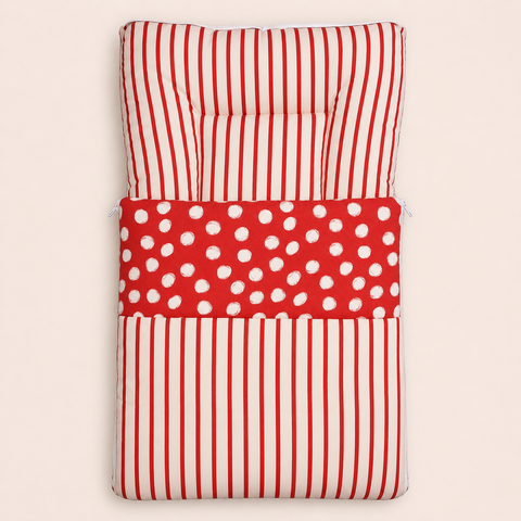 Soft cushioned baby carry nest laid flat unzipped in red and cream stripe pattern