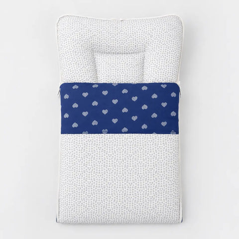 Soft cushioned baby carry nest laid flat unzipped in light grey mini triangle pattern