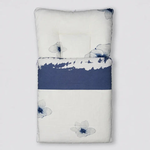 Soft cushioned baby carry nest laid flat unzipped in ivory and blue floral pattern
