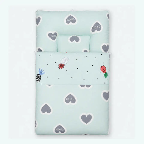 Soft cushioned baby carry nest laid flat unzipped in mint green grey heart pattern