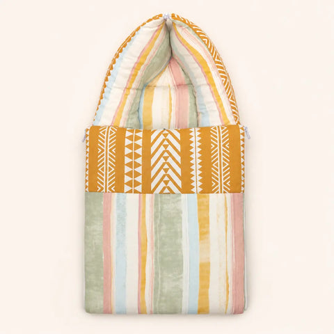 Soft cushioned baby carry nest laid flat unzipped in pastel stripe pattern