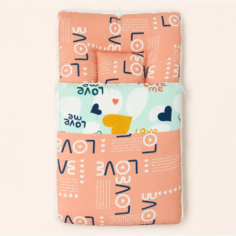 Soft cushioned baby carry nest laid flat unzipped in peach love typography pattern